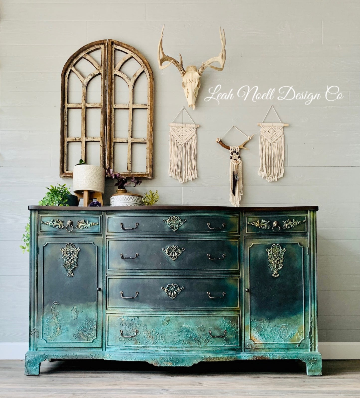 Golden Emblem Decor Mould castings applied to a teal painted dresser, adding ornate raised embellishments to the cabinet doors and drawer fronts for a dramatic vintage furniture makeover.