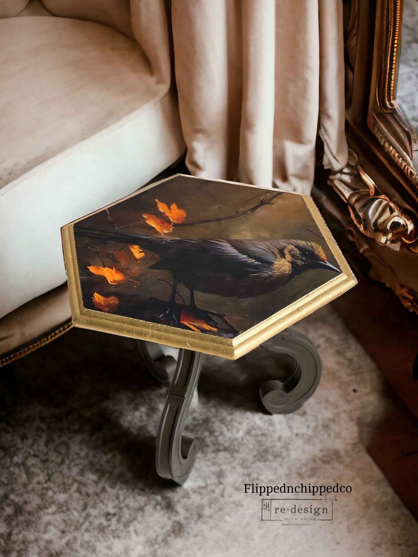 Avian Dreamscape bird decoupage tissue paper applied to the top of a small hexagon side table with a gold edge and dark curved legs.