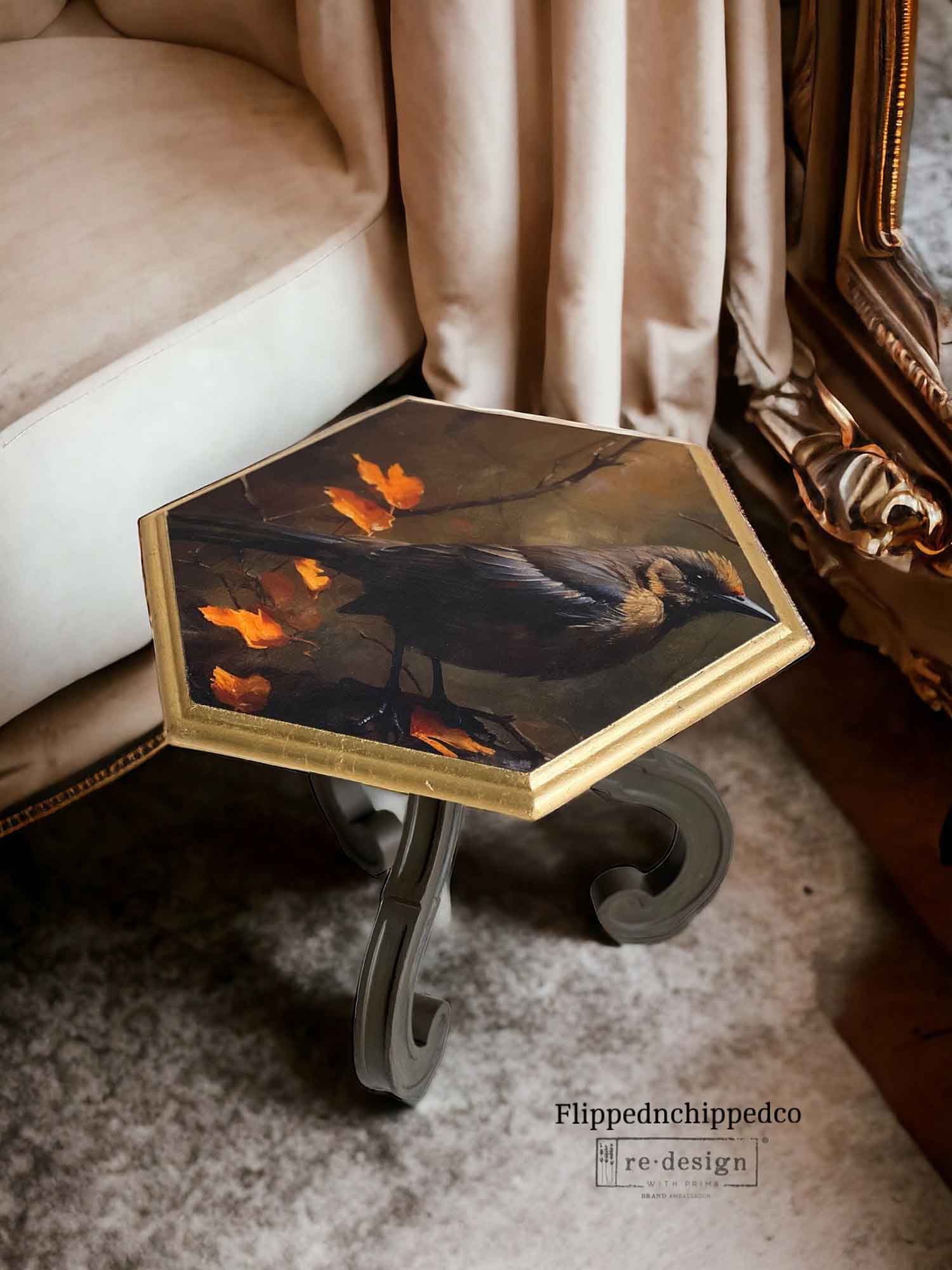Avian Dreamscape bird decoupage tissue paper applied to the top of a small hexagon side table with a gold edge and dark curved legs.