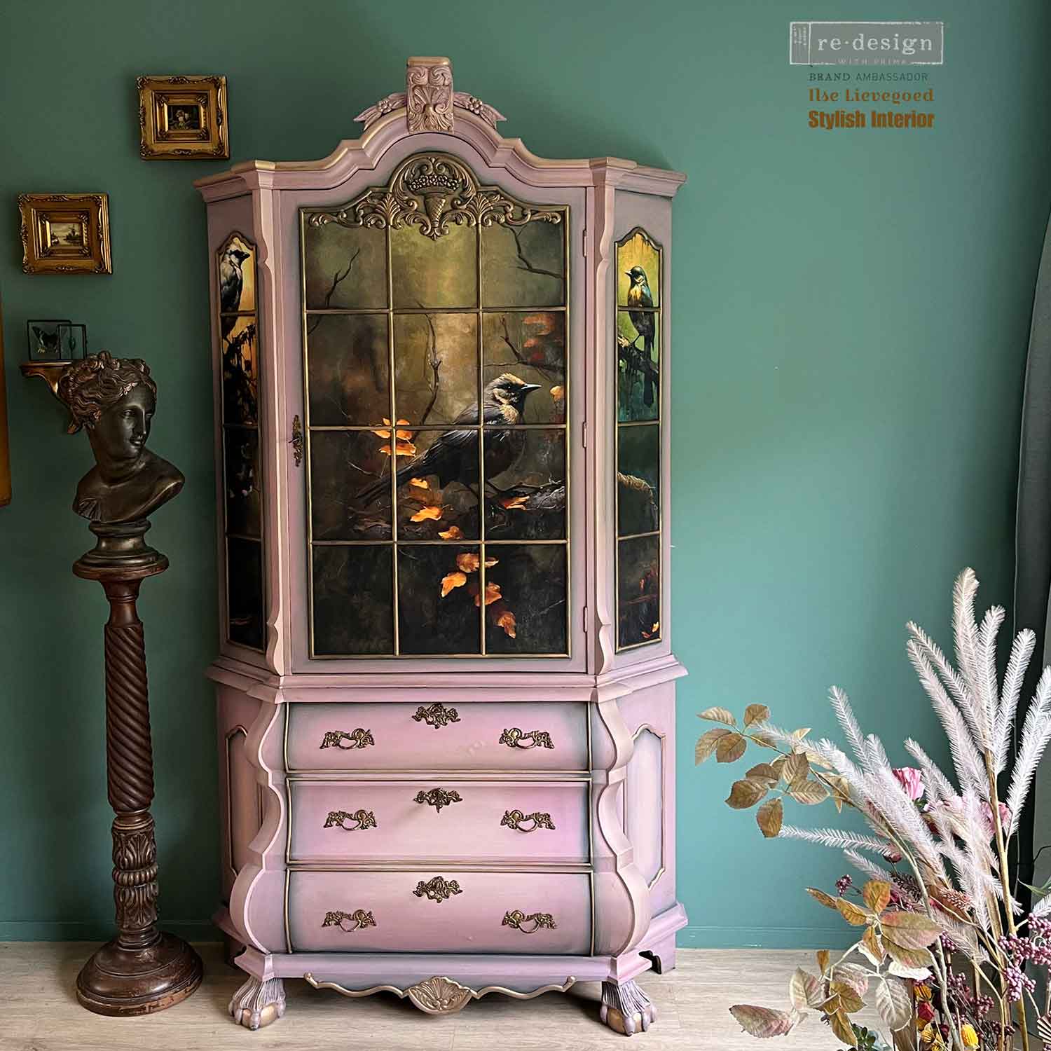 Avian Dreamscape decoupage tissue paper applied to the glass panels of an ornate vintage display cabinet painted soft blush pink with antique gold details.