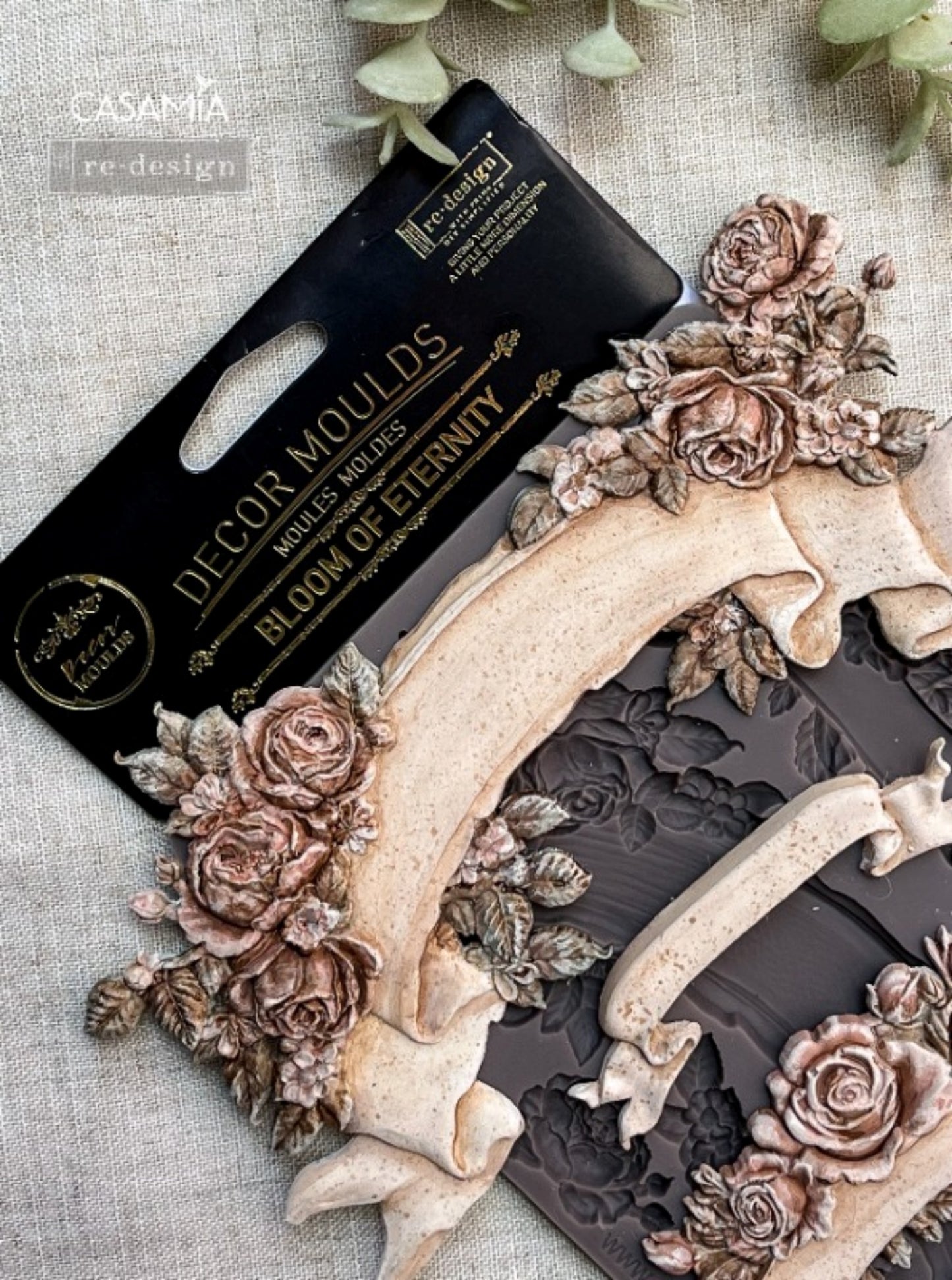 Close-up of Bloom Of Eternity Decor Mould showing raised rose clusters, leafy accents, and ribbon banner details for craft projects.