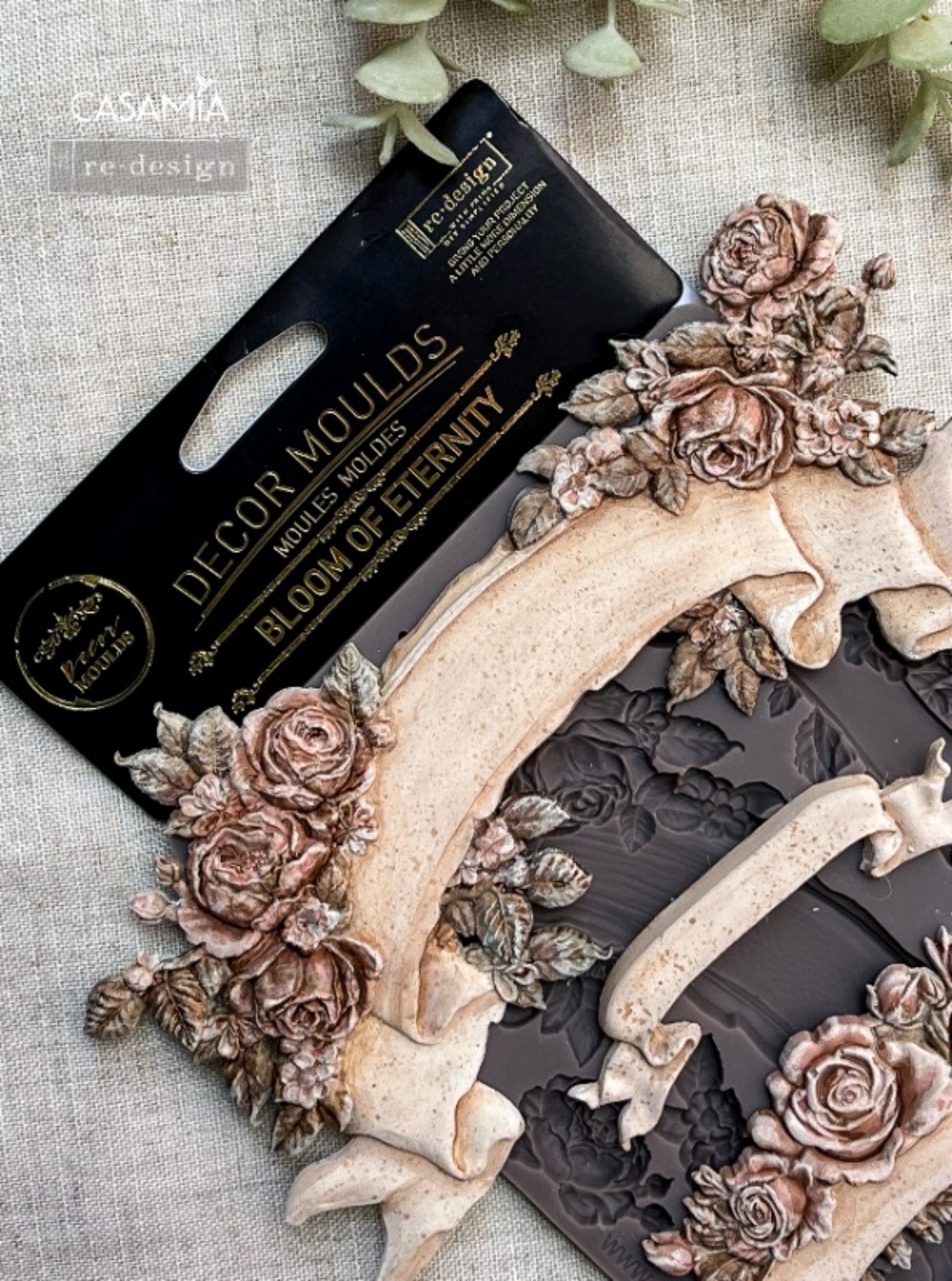 Close-up of Bloom Of Eternity Decor Mould showing raised rose clusters, leafy accents, and ribbon banner details for craft projects.