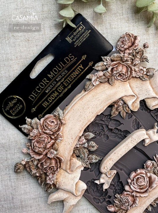 Close-up of Bloom Of Eternity Decor Mould showing raised rose clusters, leafy accents, and ribbon banner details for craft projects.