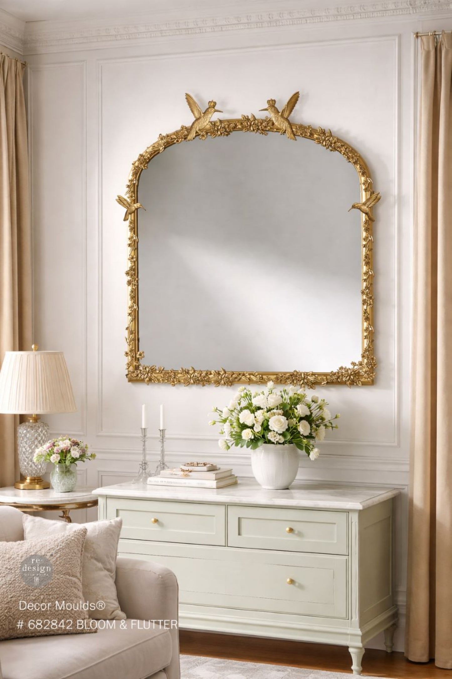 Garden-inspired Bloom & Flutter silicone mould featuring flying hummingbirds, soft flowers, leafy branches, and decorative crown embellishments shown on a gold mirror