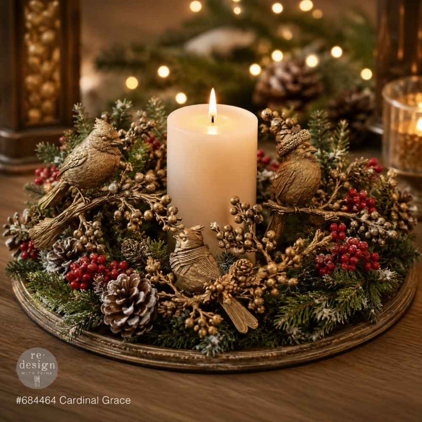 Christmas candle centerpiece decorated with gold Cardinal Grace birds, branches, berries, pinecones, and evergreen greenery.