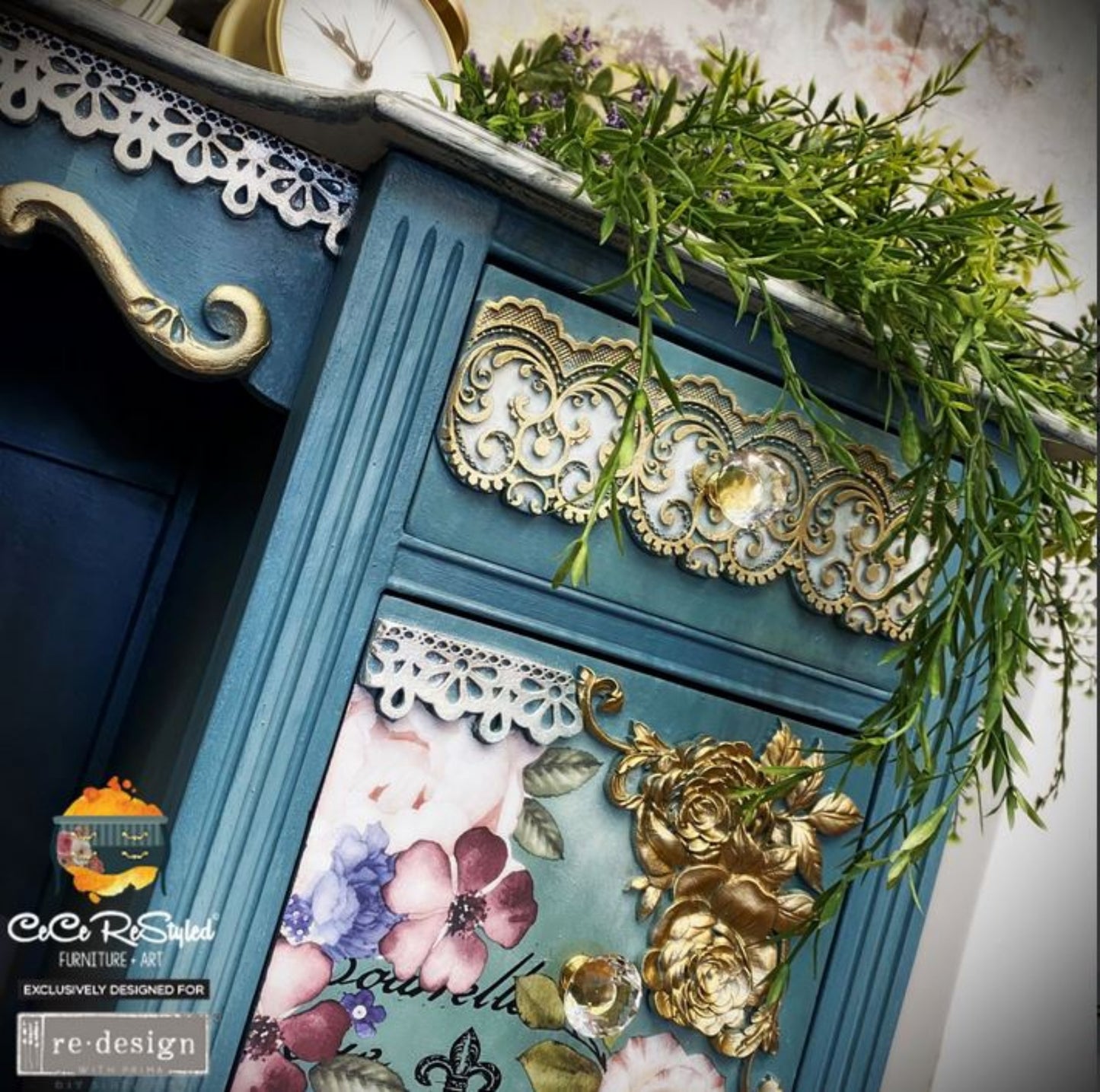 Close-up of Border Lace II lace trim mould castings on a teal furniture drawer with raised scrollwork, gold accents, floral panels, and decorative trim.