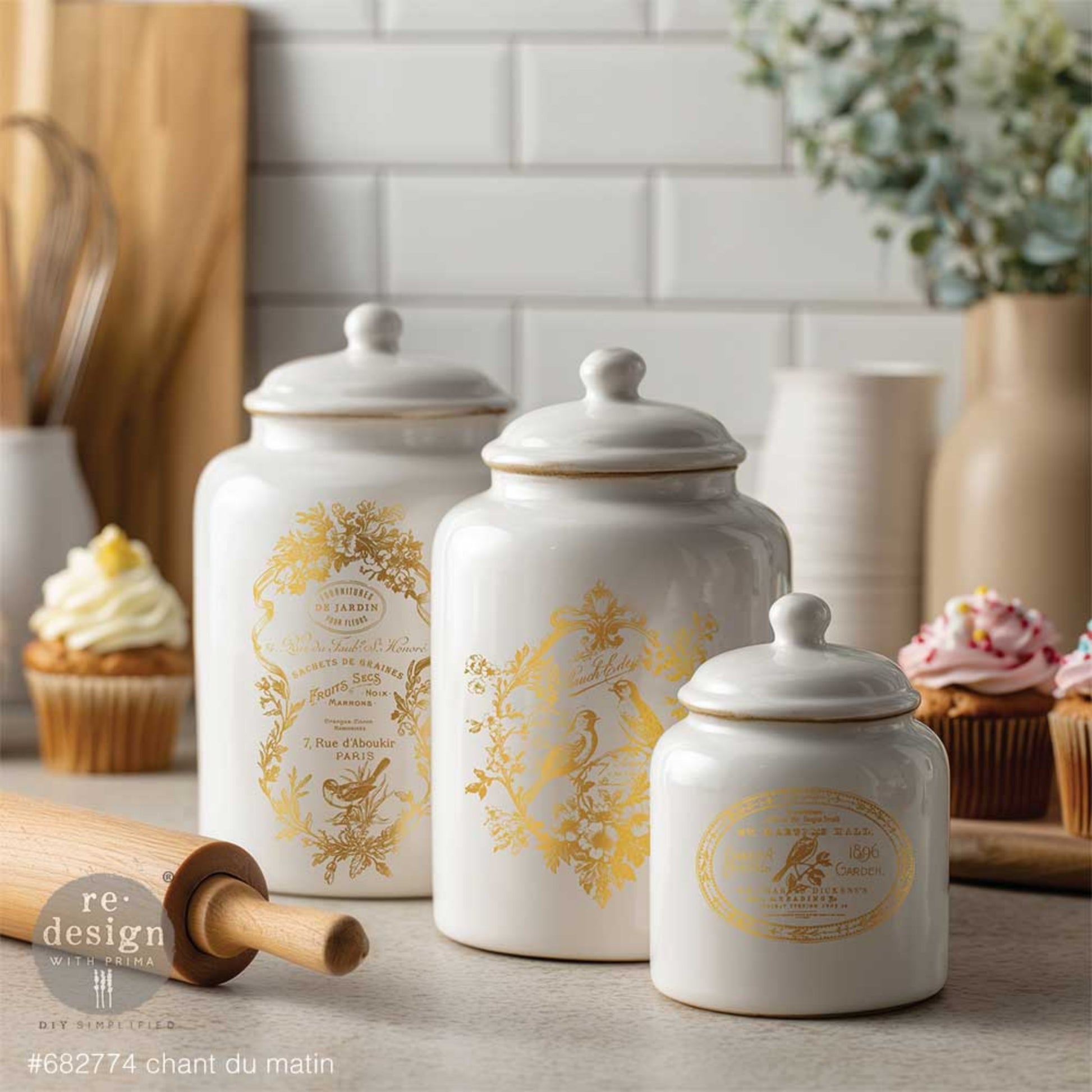 Gold Chant Du Matin water slide transfers on ceramic canisters with ornate French labels, birds, florals, and antique-style details.