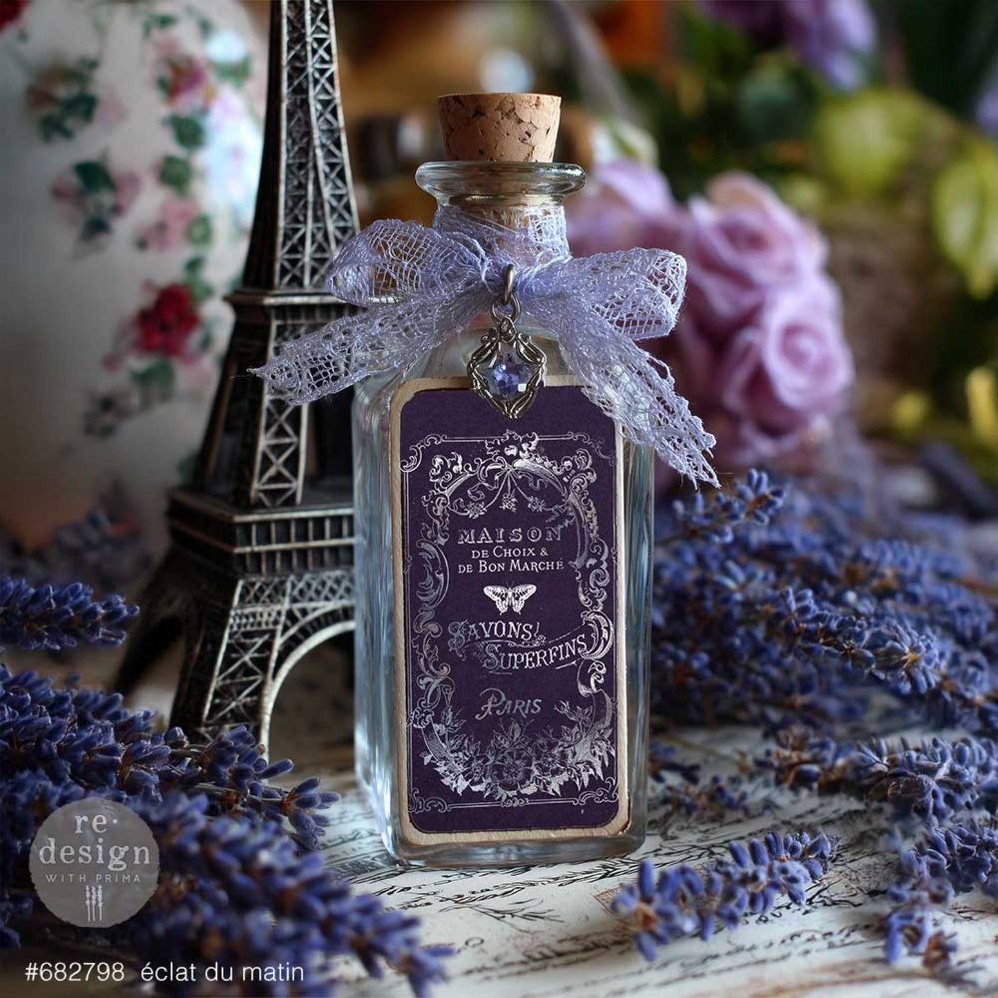 Éclat Du Matin silver transfer label applied to a glass bottle with lavender ribbon, Eiffel Tower accent, and French vintage styling.
