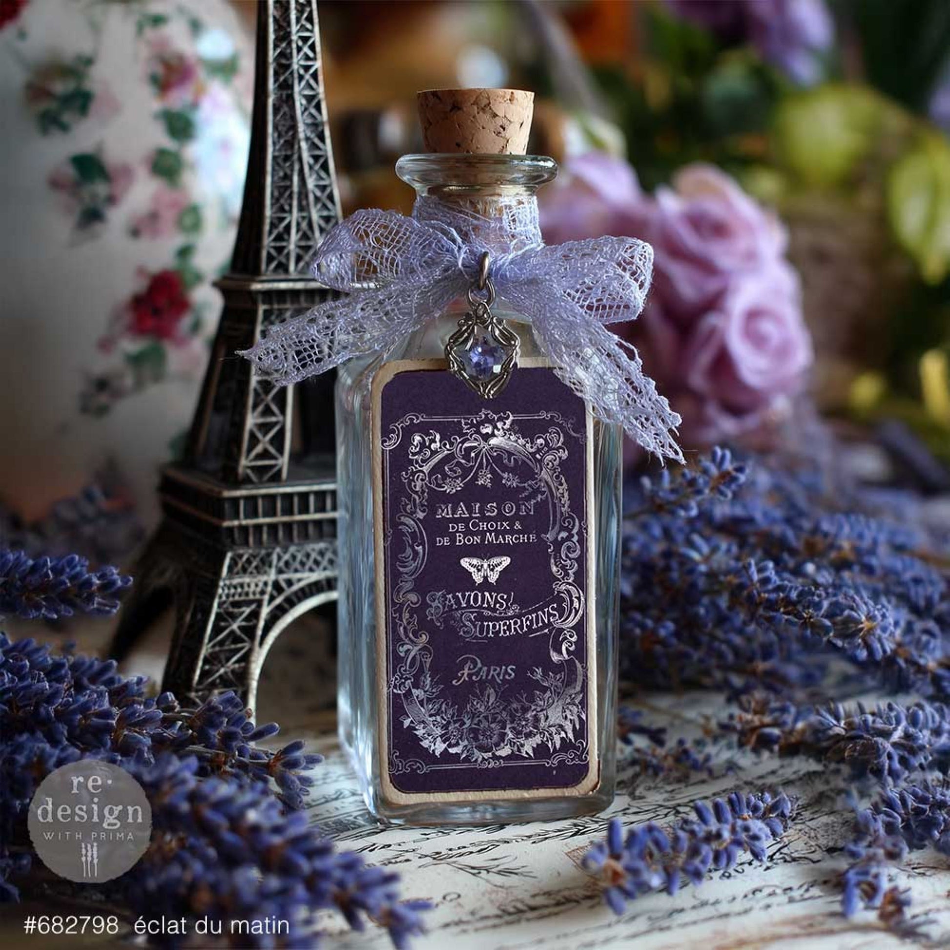 Éclat Du Matin silver transfer label applied to a glass bottle with lavender ribbon, Eiffel Tower accent, and French vintage styling.