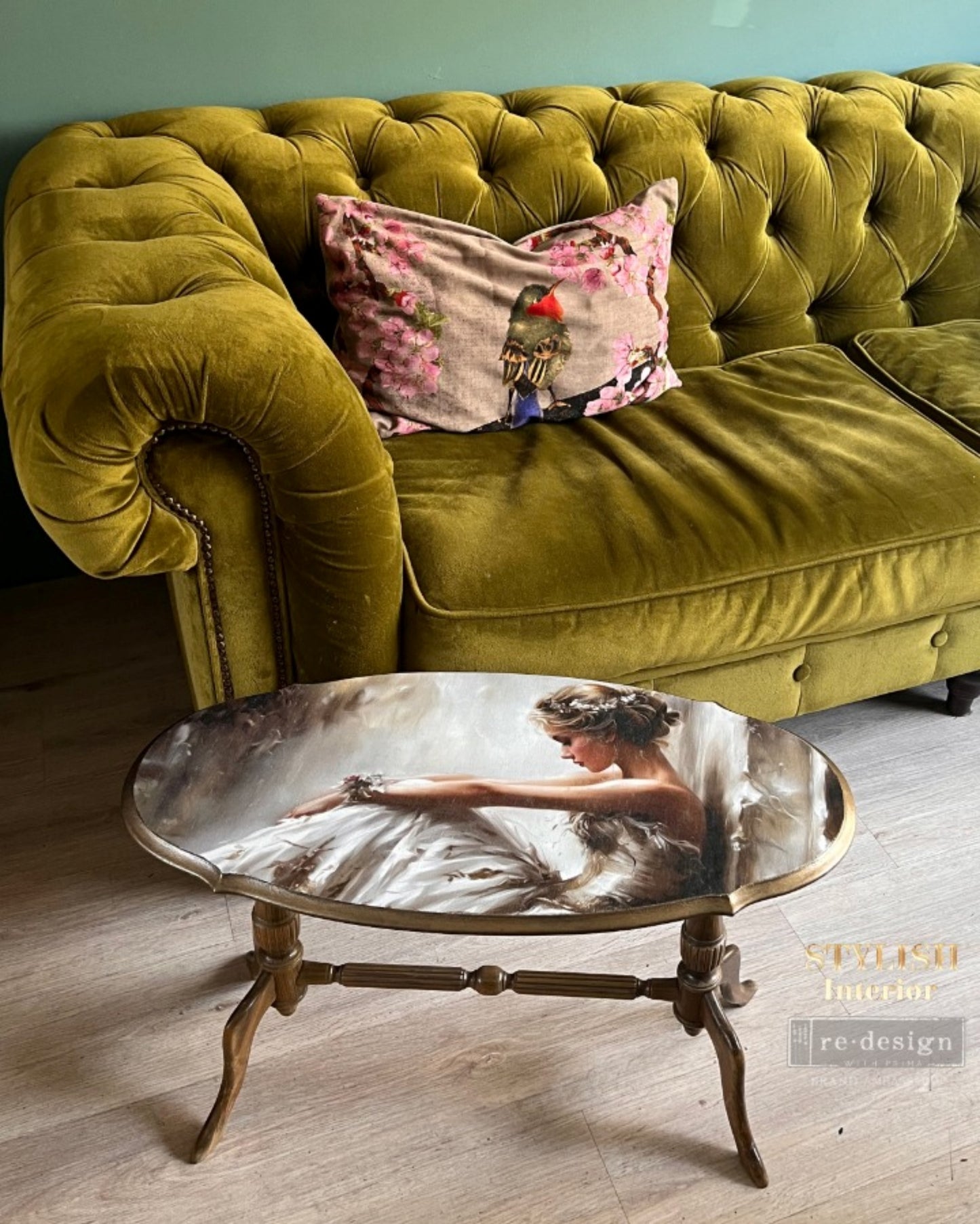 Romantic ballerina in a soft white gown seated in a dreamy neutral studio on a coffee table, A1 Decoupage Fiber Kacha ÉToile Studio by Redesign with Prima.