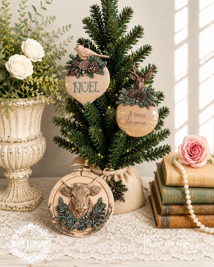 Bird and deer Evergreen Antler Emblem ornaments displayed on a small Christmas tree with a coordinating cow plaque.