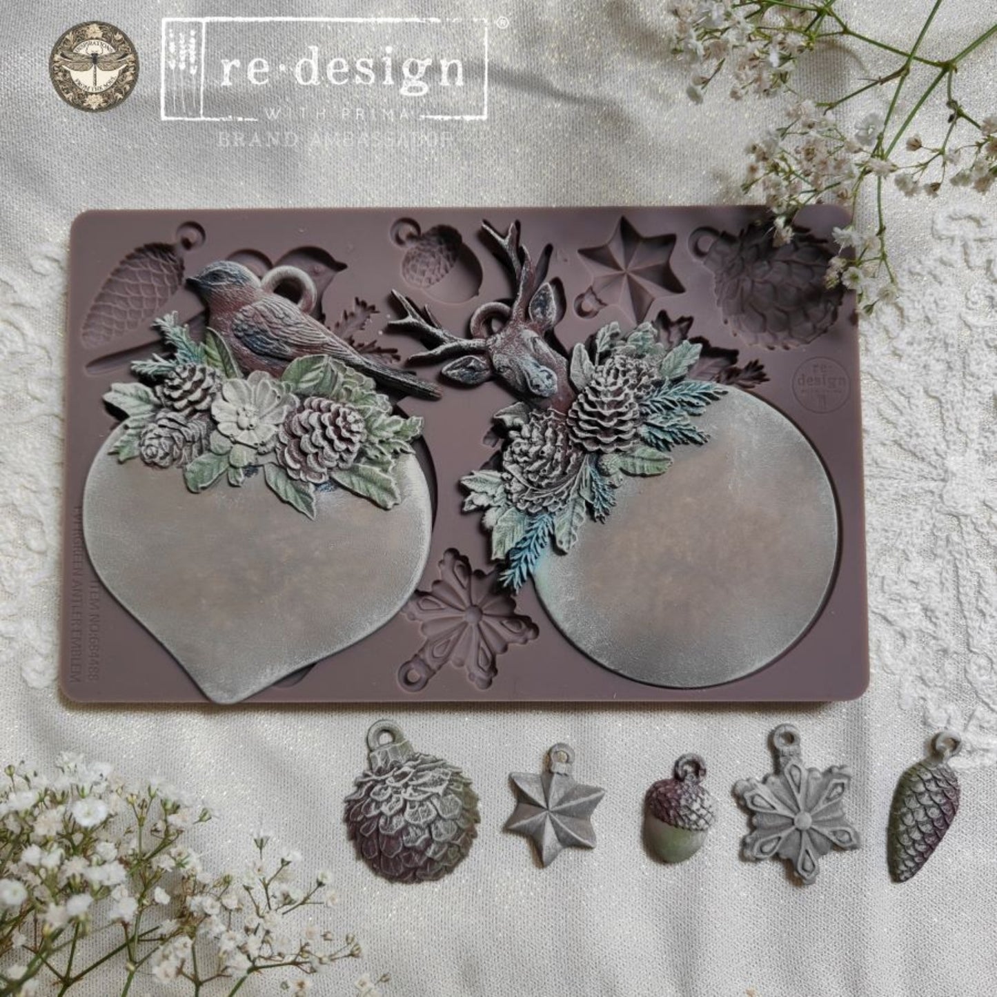 Evergreen Antler Emblem mould with finished round and heart-shaped ornament plaques plus small hanging accents.