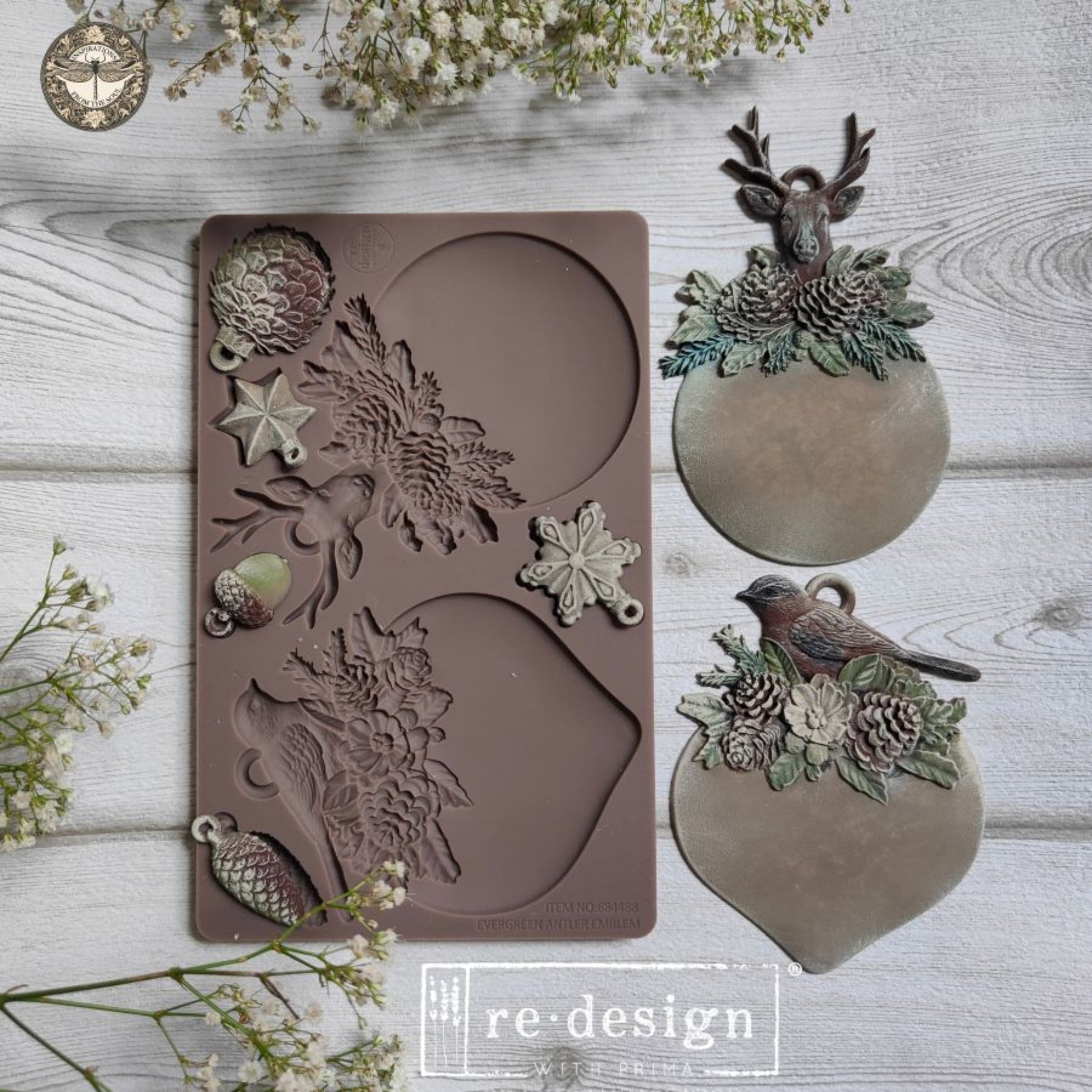 Evergreen Antler Emblem mould and completed bird and deer ornament plaques displayed on a light wood background.