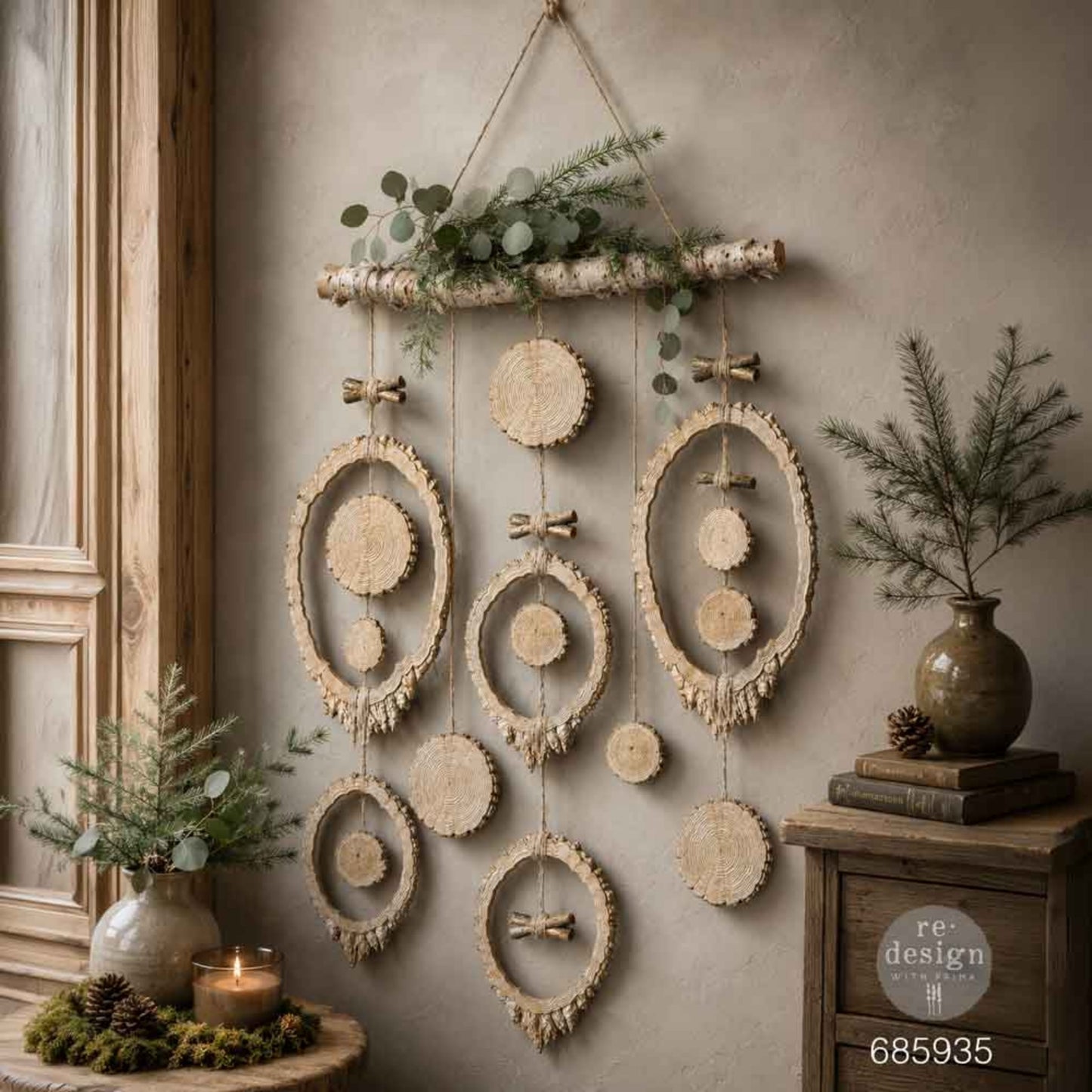 Rustic wall hanging created with Evergreen & Embers tree-ring frames, wood slices, branch details, and natural greenery.