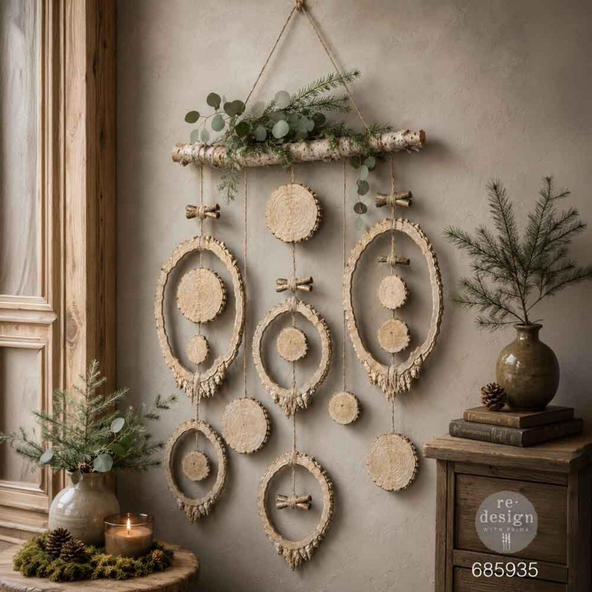 Rustic wall hanging created with Evergreen & Embers tree-ring frames, wood slices, branch details, and natural greenery.