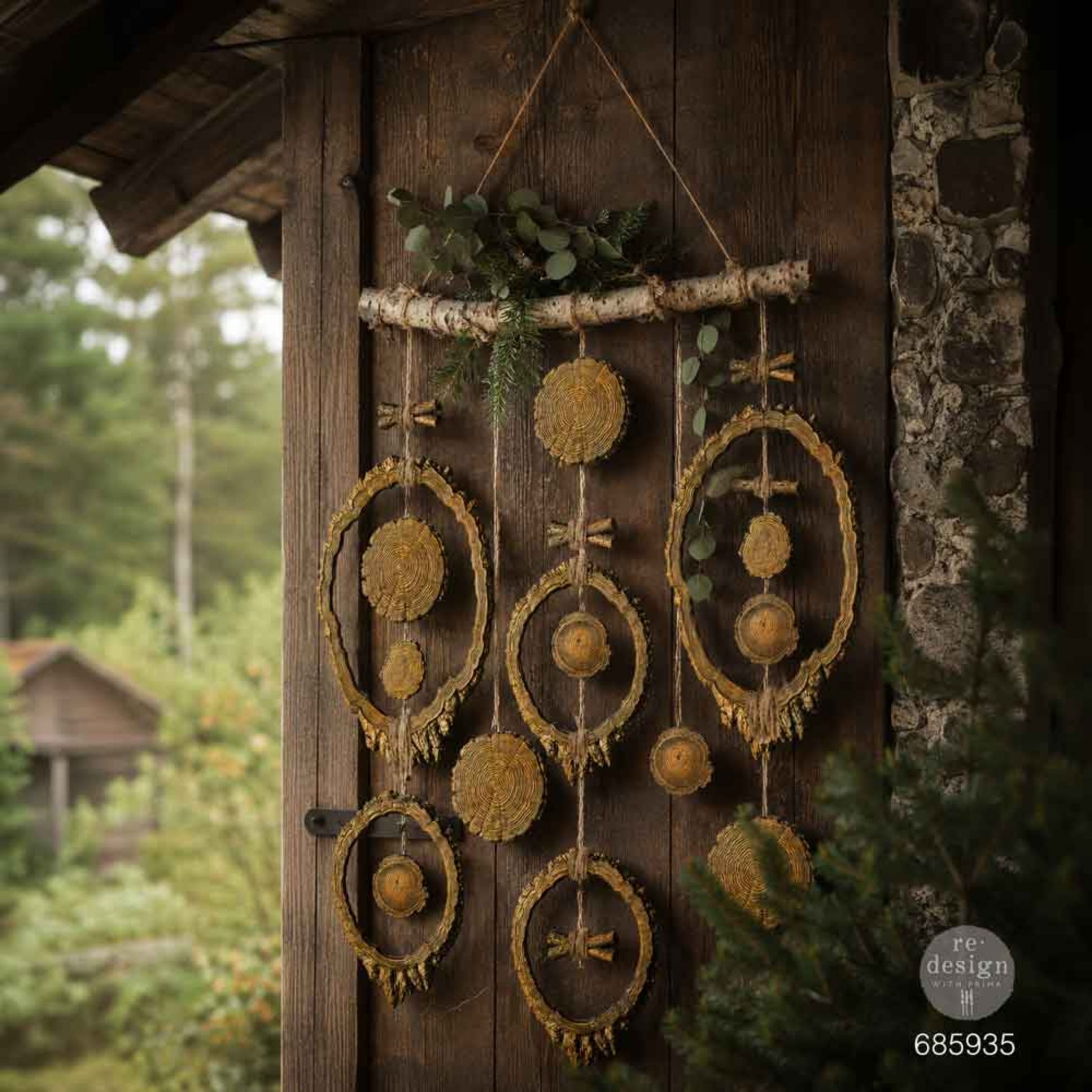Evergreen & Embers wood-slice wall hanging displayed on a dark rustic cabin wall.