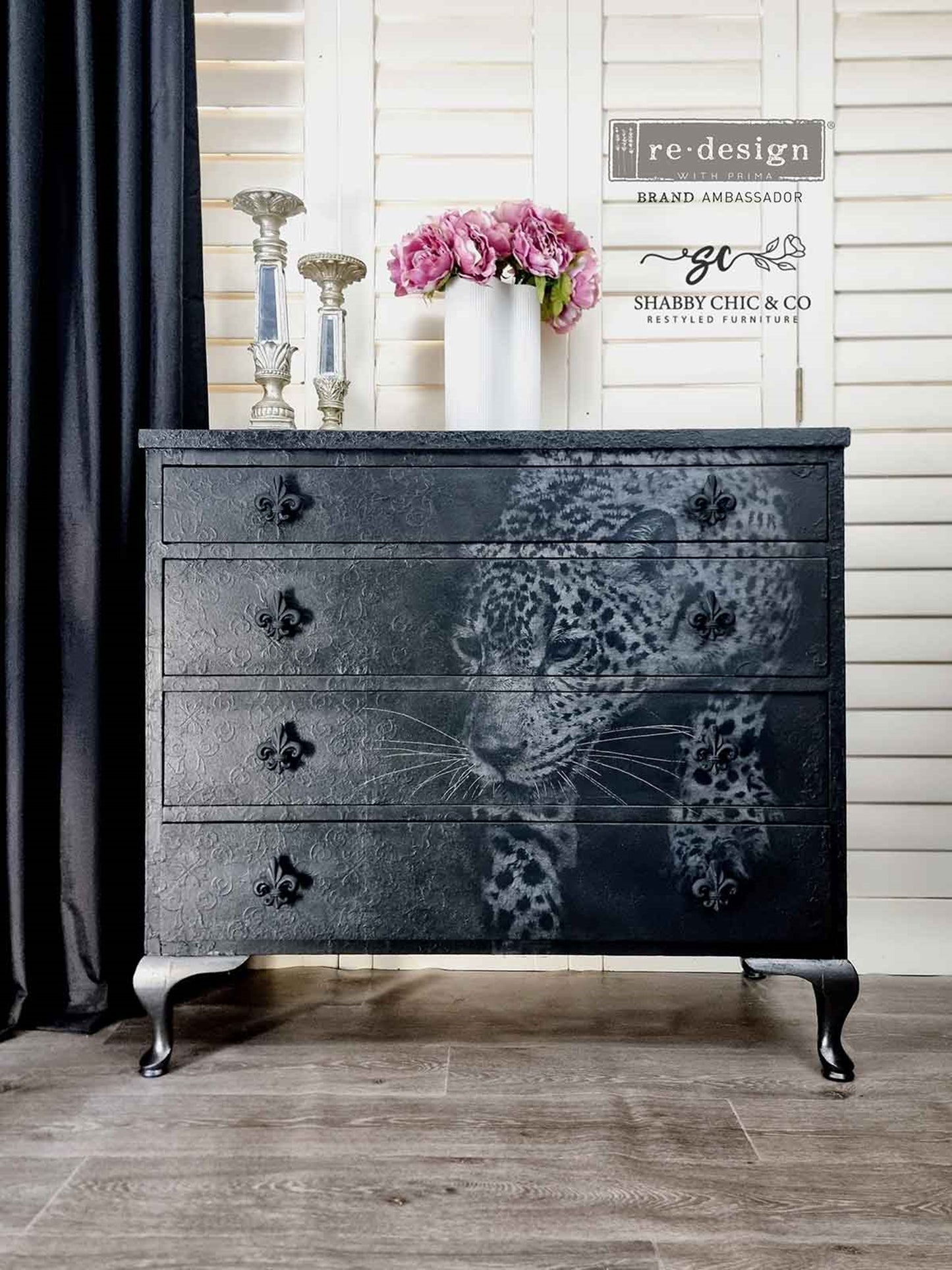 Feline Gaze decoupage paper applied to a black four-drawer dresser with fleur-de-lis knobs and textured detailing.