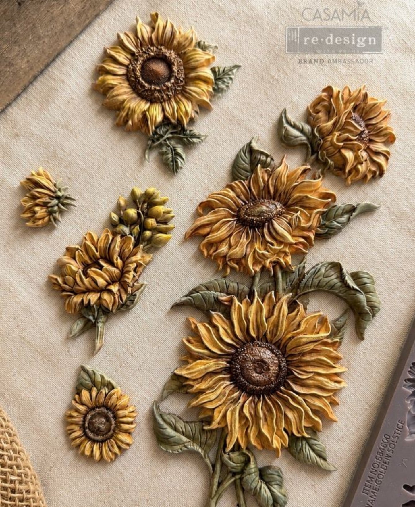 Painted Golden Solstice sunflower castings in several sizes with green leaves and detailed golden petals.