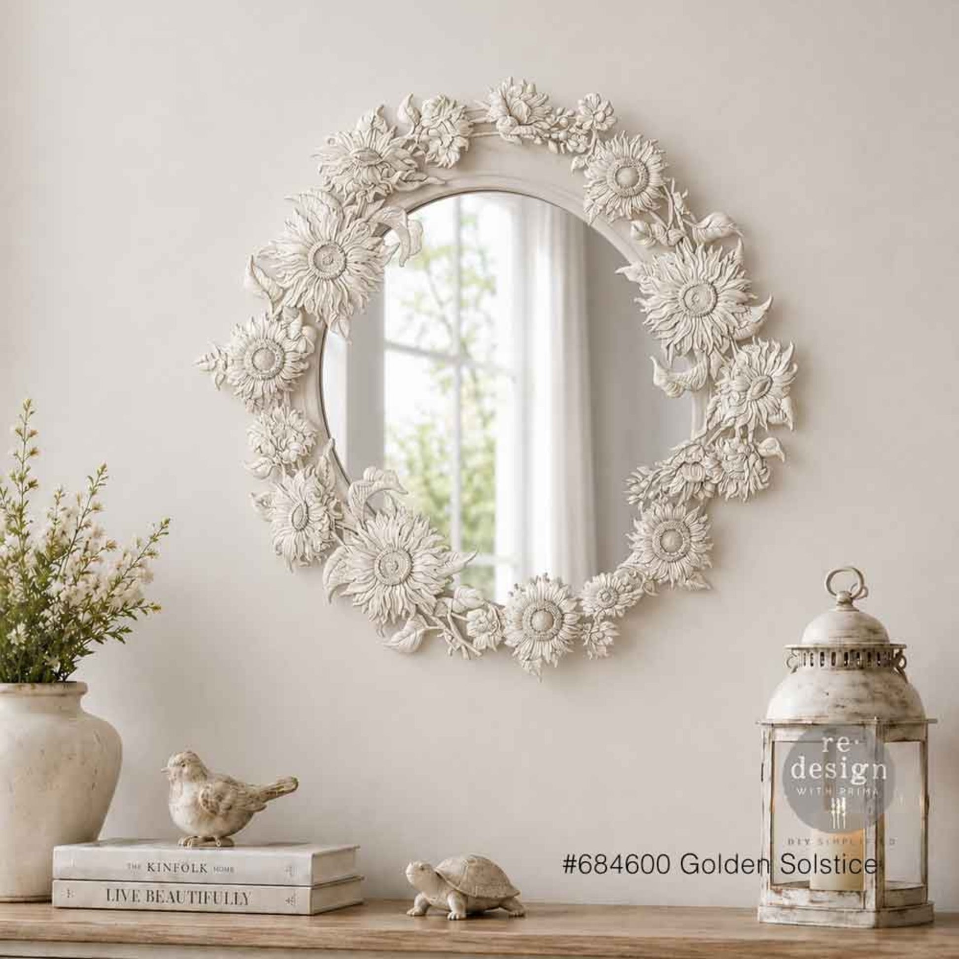 White oval mirror decorated with Golden Solstice sunflower castings for a soft farmhouse-style finish.