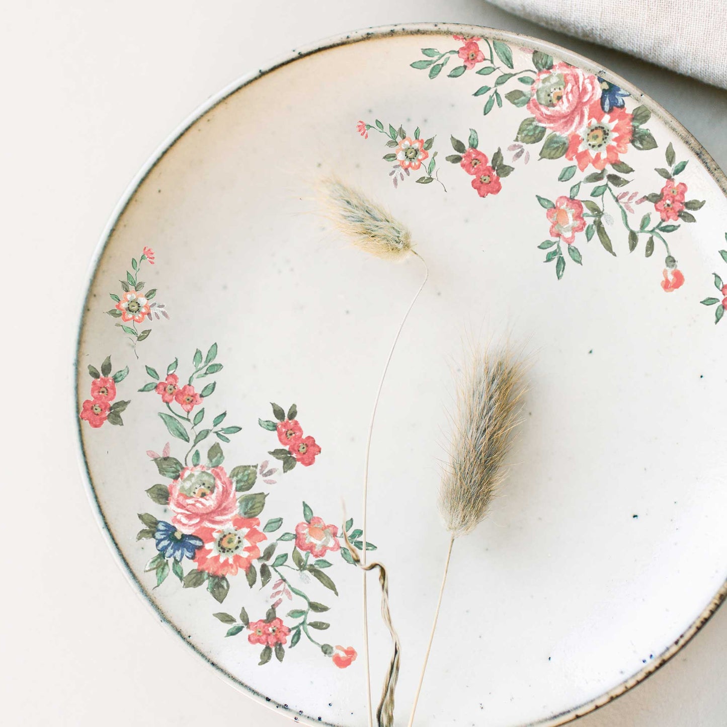 Gorgeous Flora H2O floral transfers applied around the edge of a round white decorative tray with soft pink, coral, blue, and green flowers.