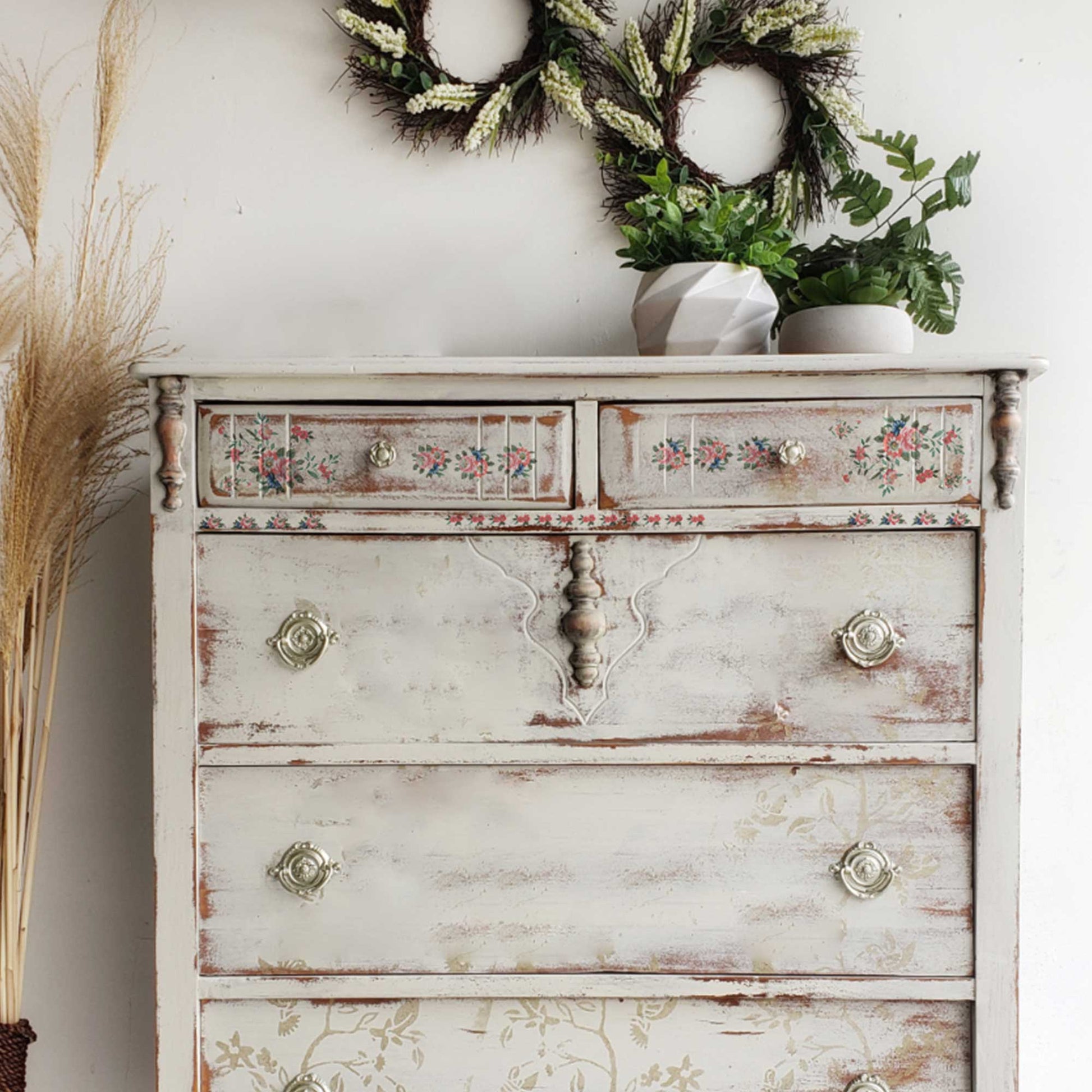 Vintage white dresser makeover featuring Gorgeous Flora H2O floral accents across the top drawers and decorative trim.