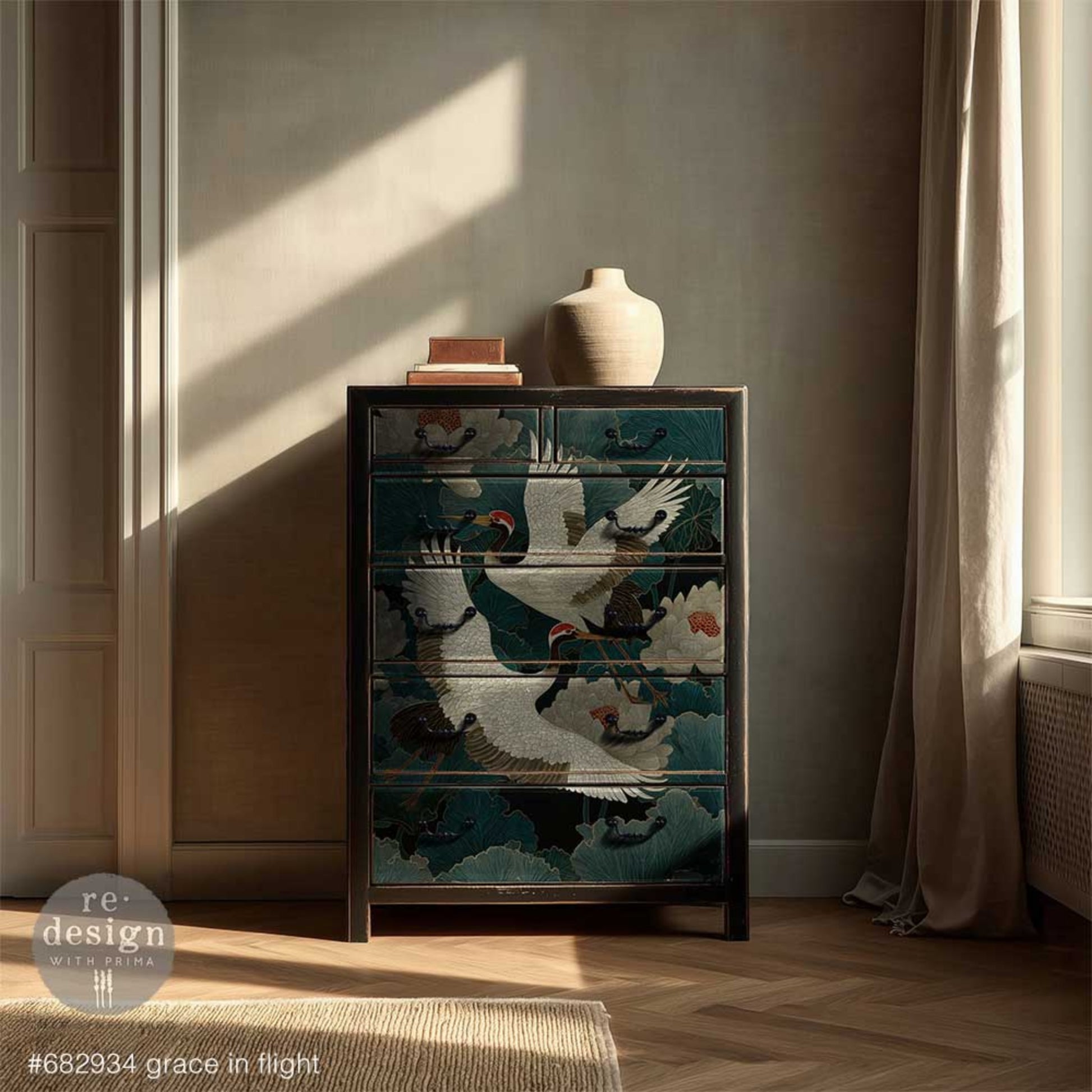Grace In Flight tissue paper shown with graceful cranes in flight and bold chinoiserie style design on a dresser