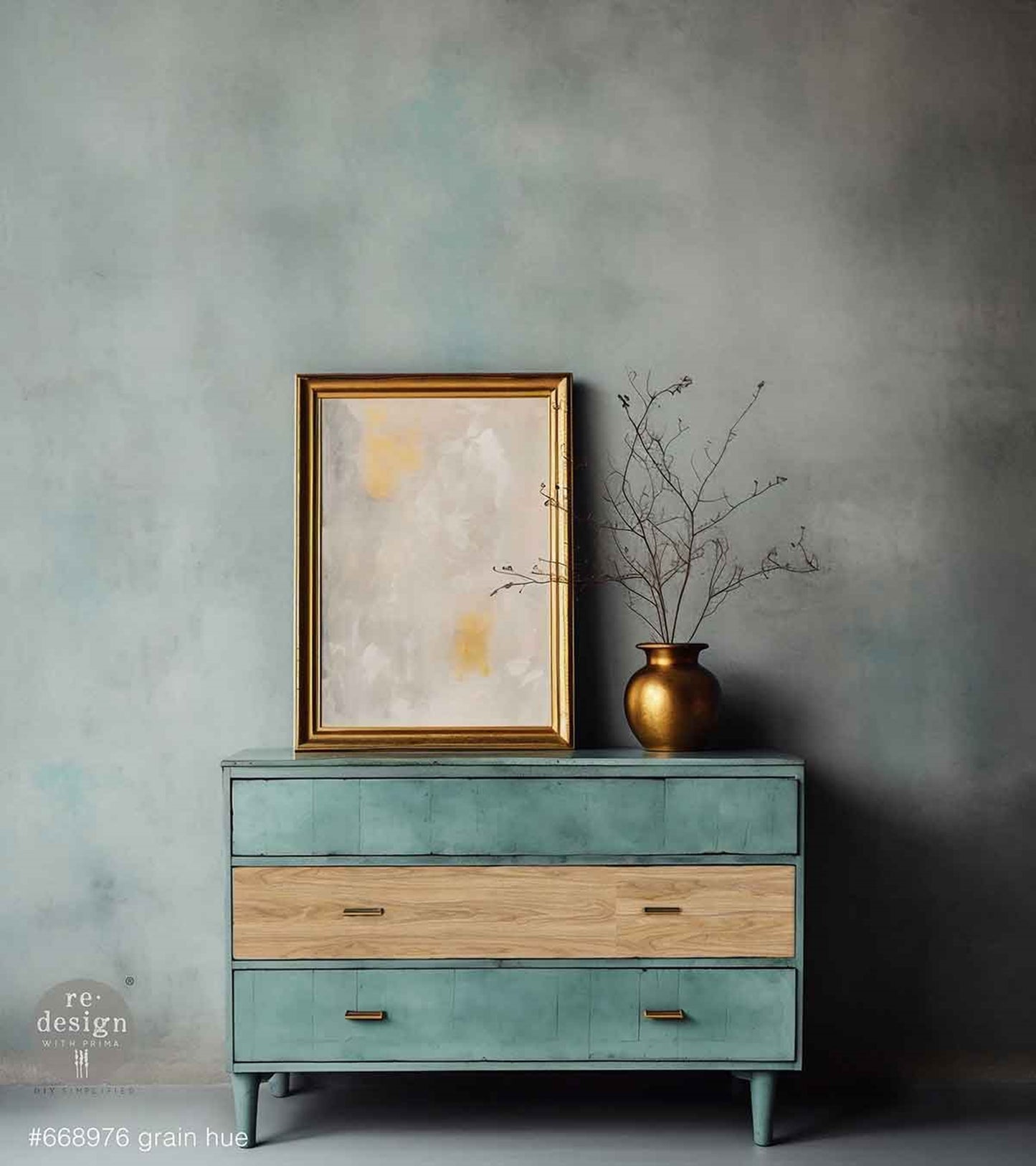 Grain Hue decoupage fiber paper used as a natural wood-grain accent on the center drawer of a distressed aqua dresser with brass hardware.
