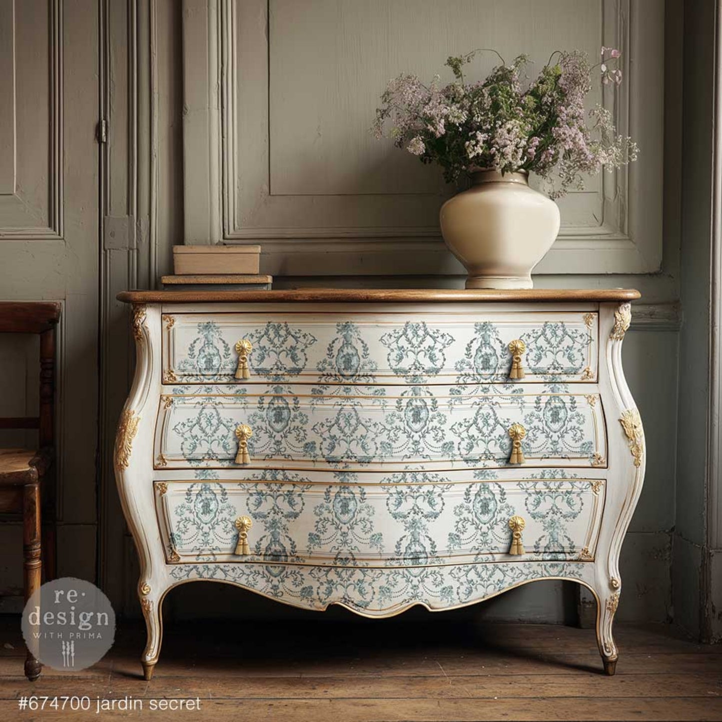 Cherub Decor Transfer featuring laurel wreaths, bows, floral swags, and ornate framed details on a dresser