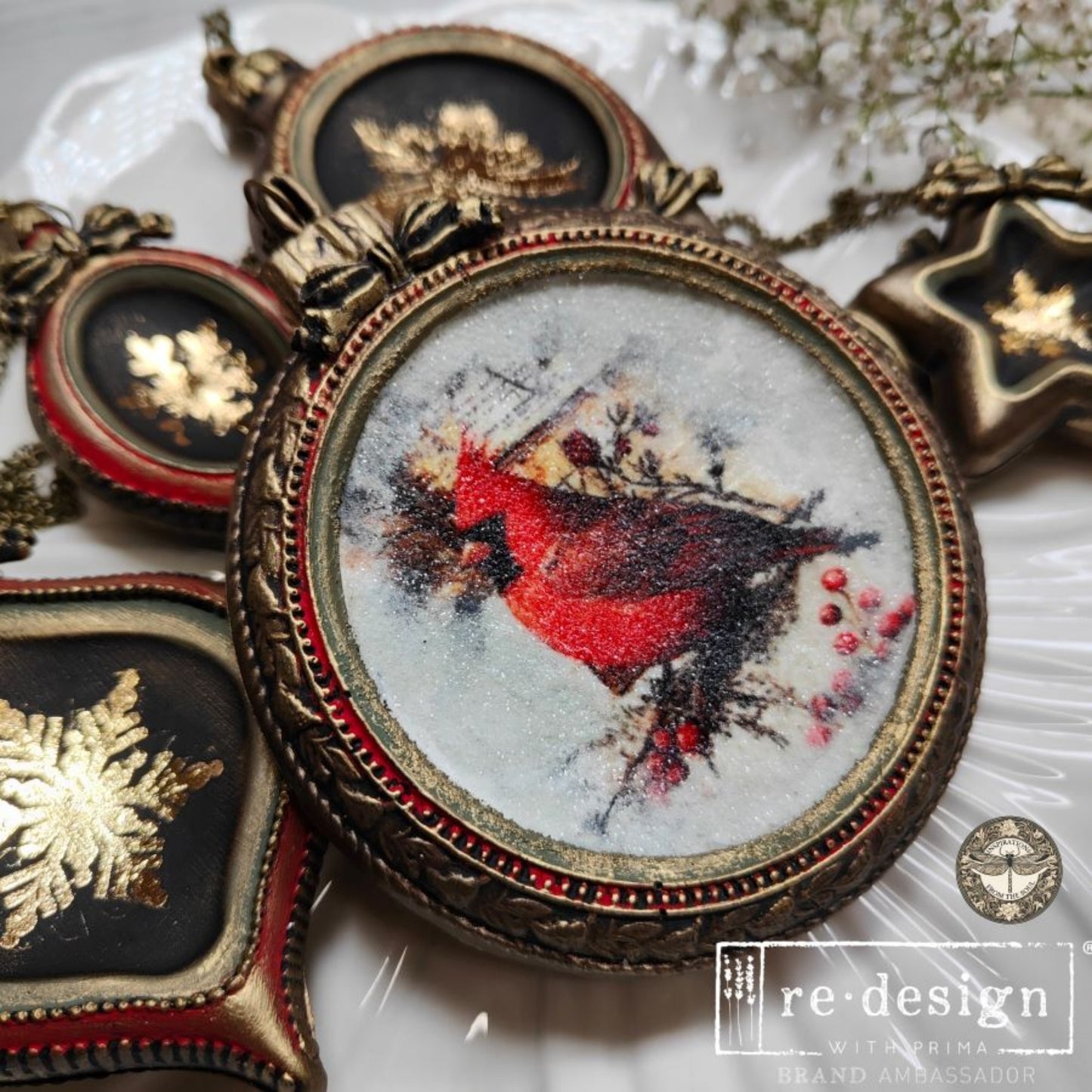 Bronze-look molded ornaments with gold holiday designs, including Santa and snowflakes, arranged on a white plate.