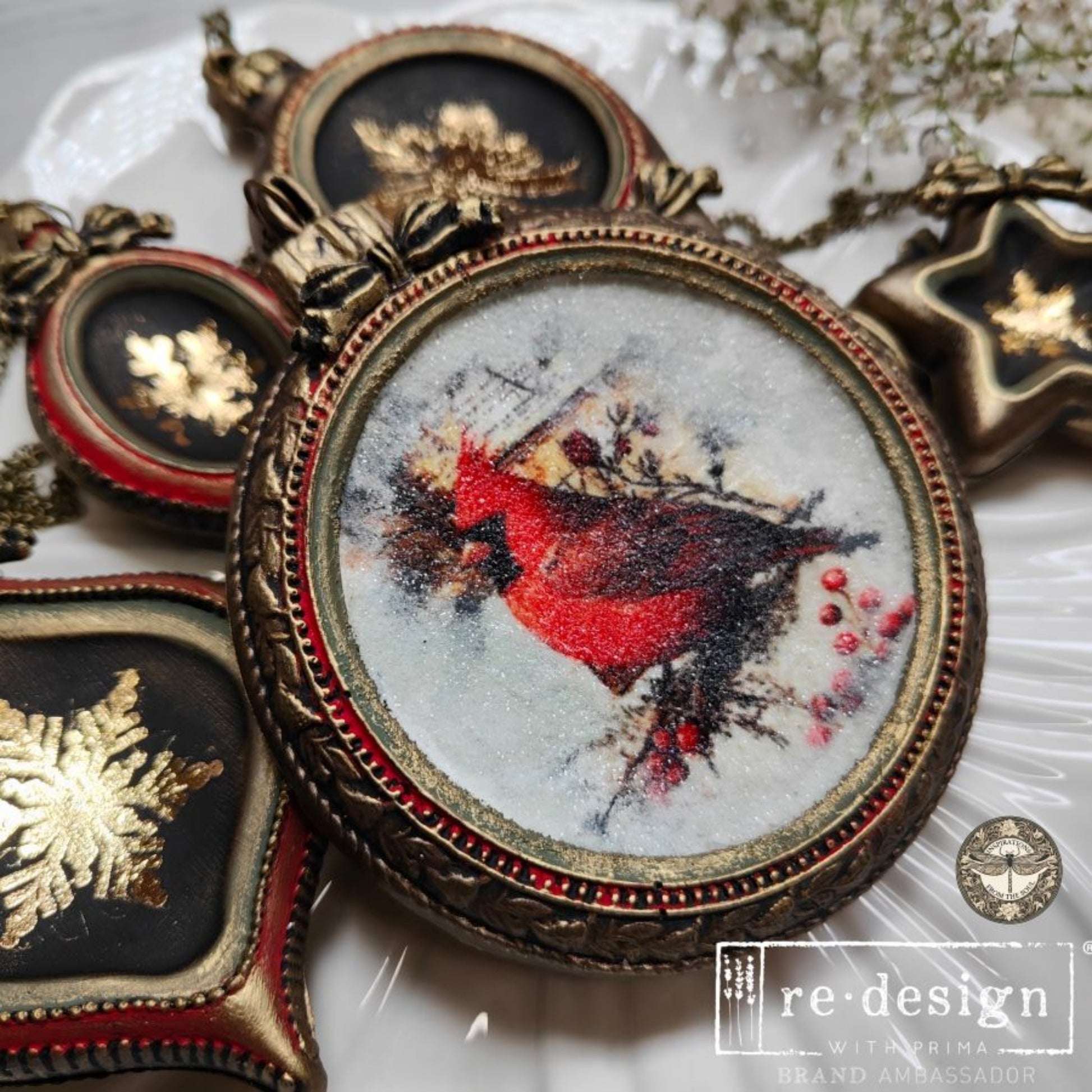 Bronze-look molded ornaments with gold holiday designs, including Santa and snowflakes, arranged on a white plate.