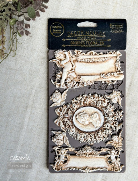 Redesign with Prima Ombres Florales silicone decor mould with cameo portrait, ornate frames, floral wreath, cherubs, bows, and vintage scroll details.