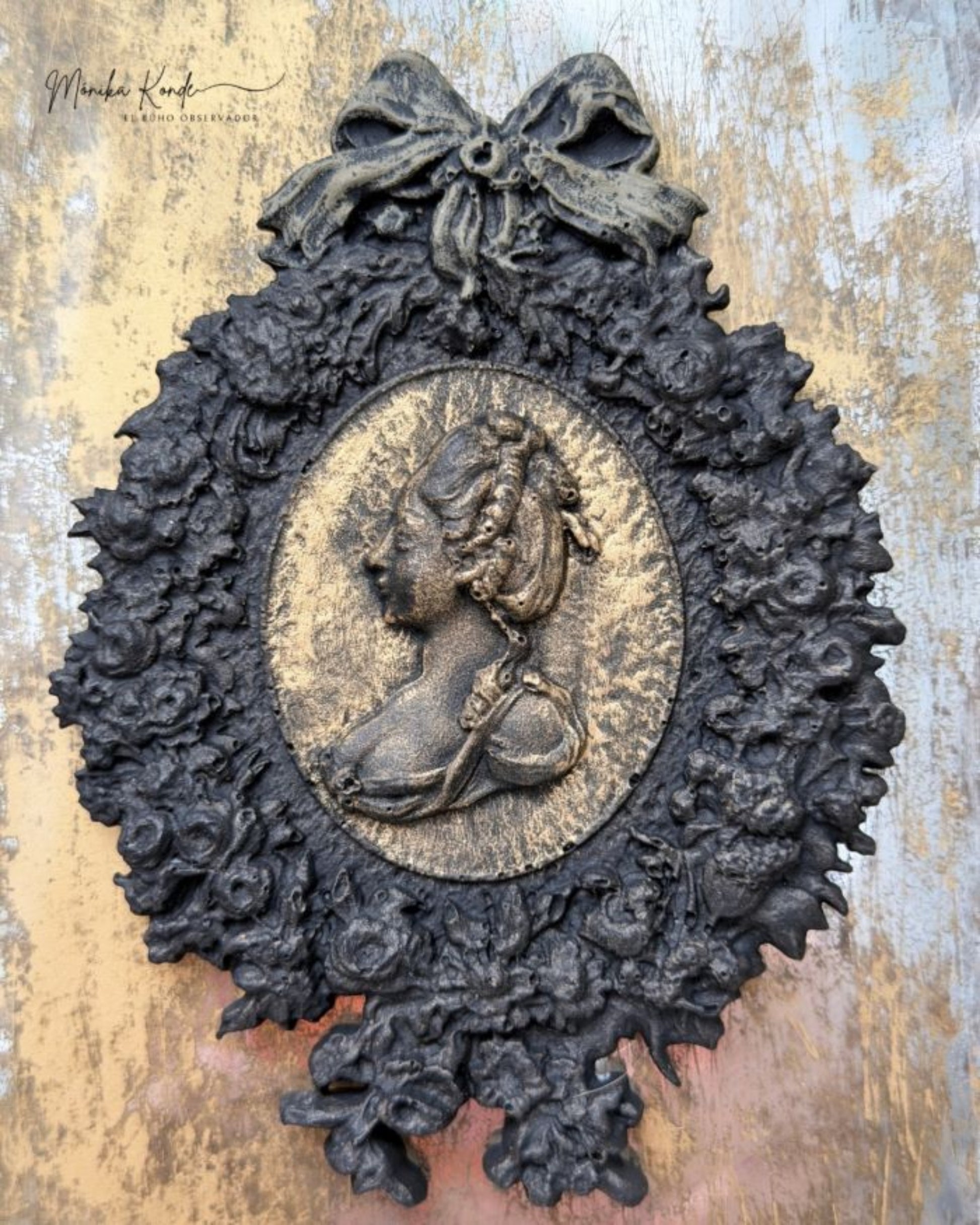 Close-up of Ombres Florales silicone mould with detailed cameo portrait, romantic florals, decorative frame edges, and vintage scrollwork.