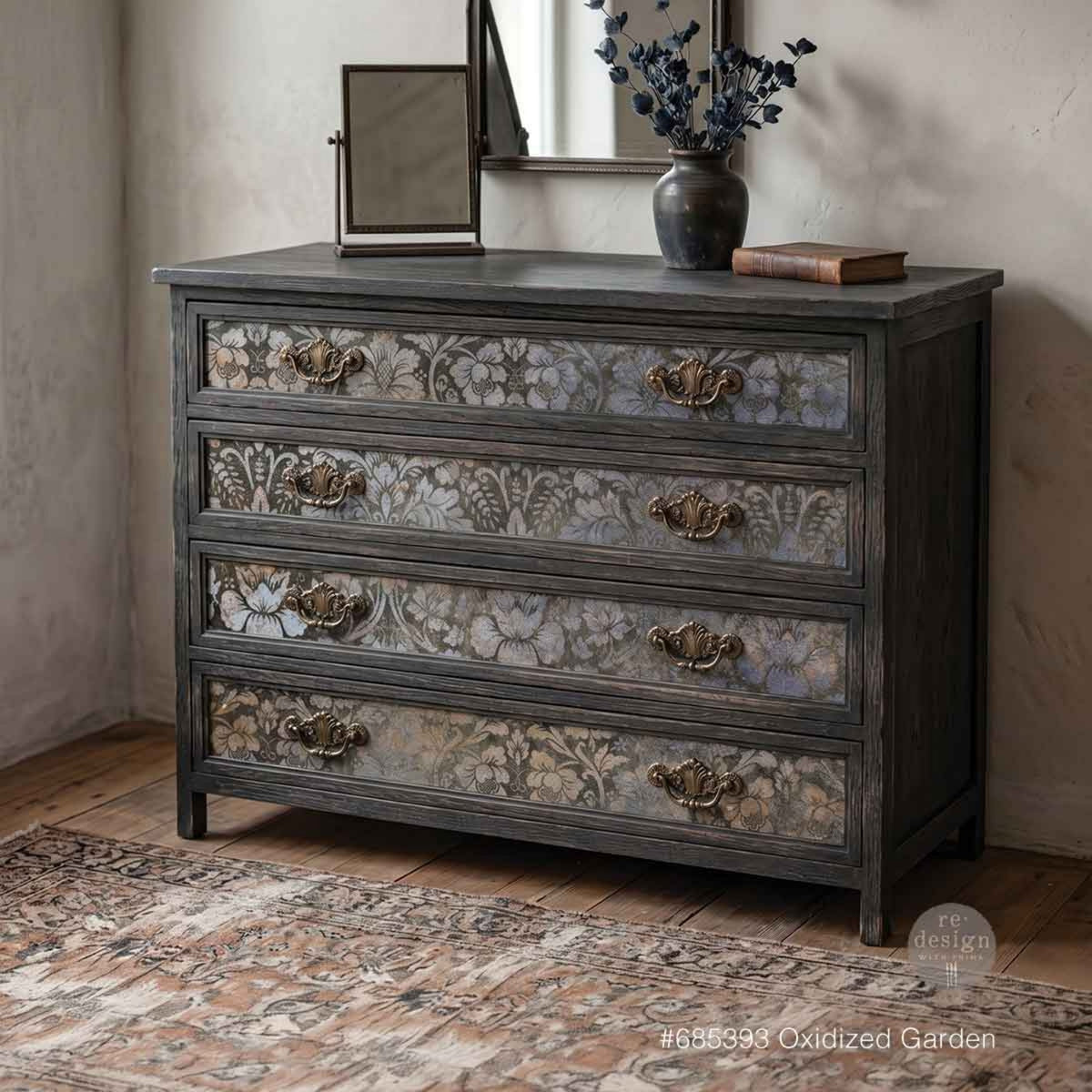 Vintage charcoal gray four-drawer dresser featuring Oxidized Garden floral decoupage paper on the drawer fronts with antique brass handles.