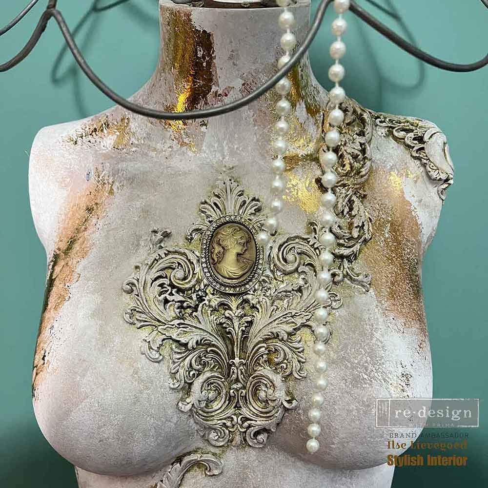 Salon De La Belle Epoque Decor Mould castings used on a mannequin bust with ornate raised scroll details, gold accents, and vintage wall art styling.