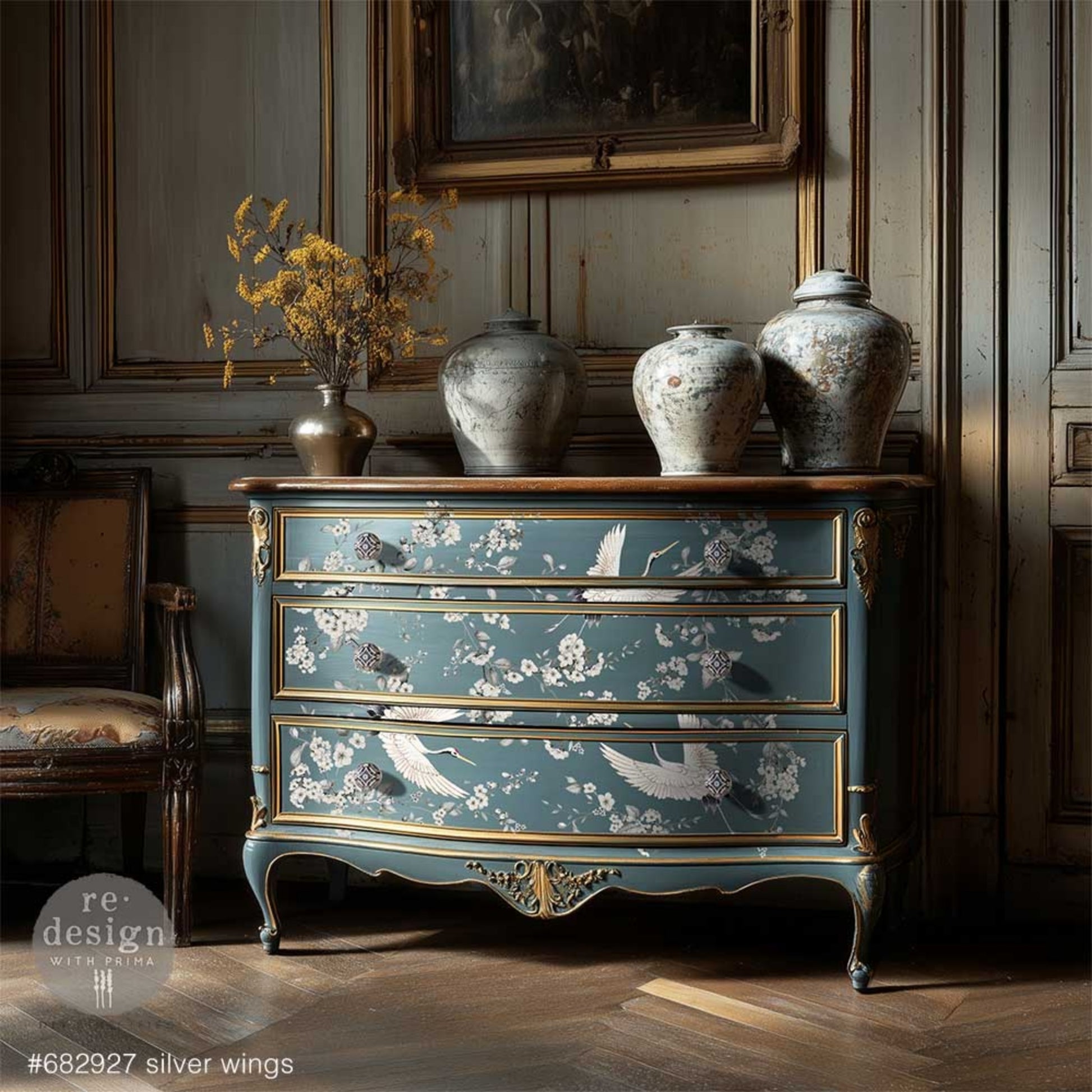 Silver Wings rub on transfer with neutral floral branches and bird details on blue dresser