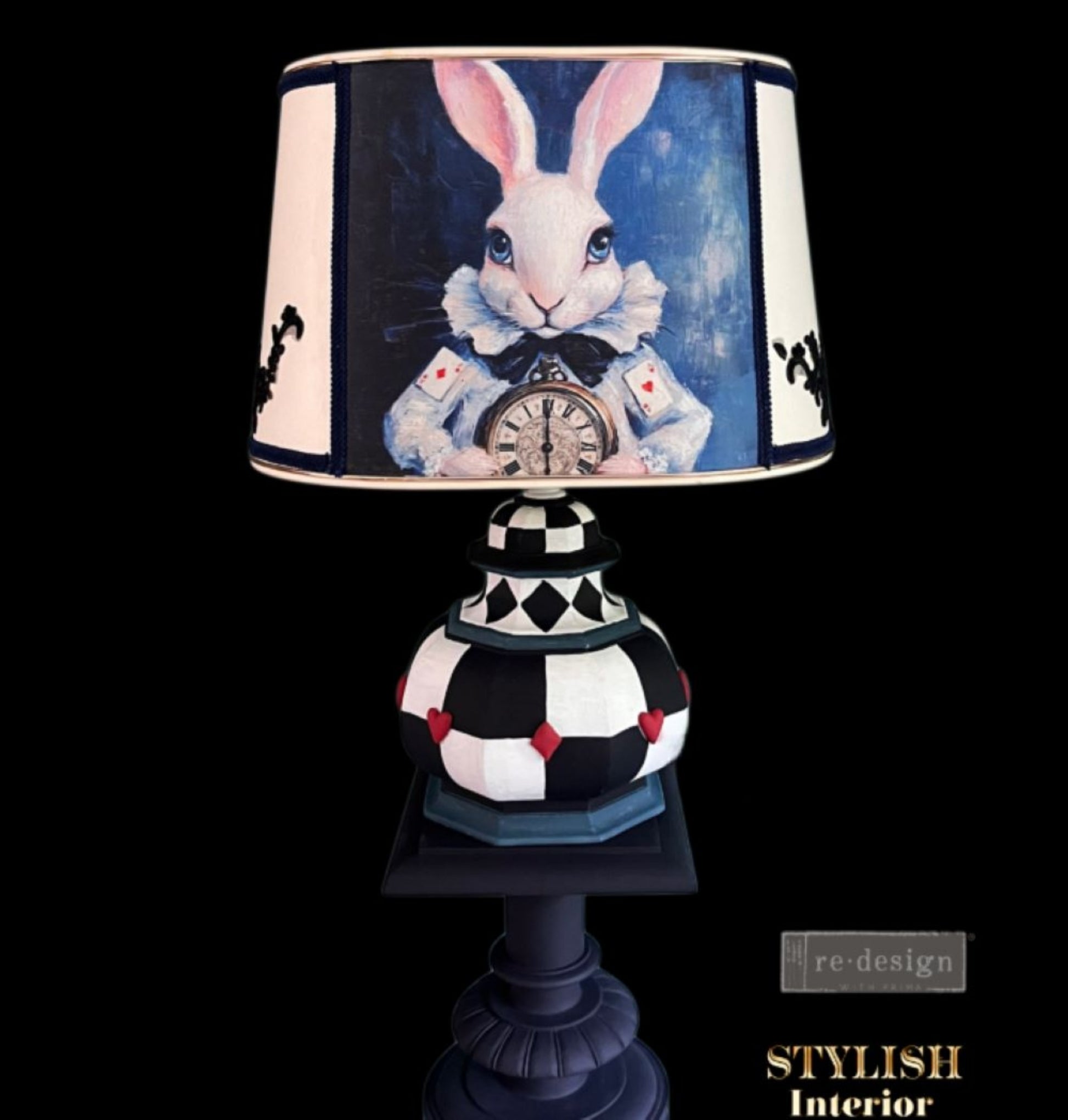 Whimsical white rabbit decoupage artwork featured on a black, white, and blue harlequin table lamp.