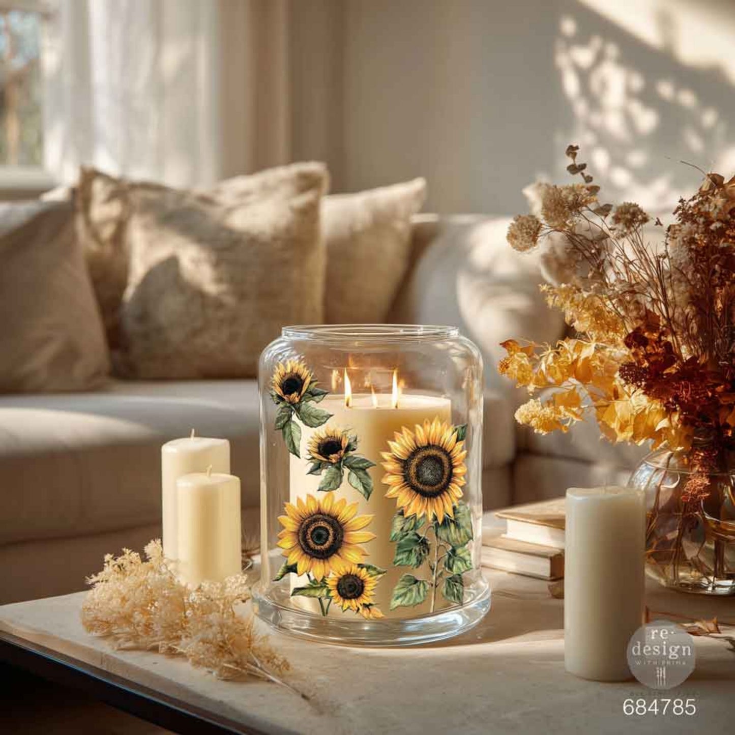 Large glass candle hurricane decorated with yellow sunflower Luxe Transfers in a warm, neutral living room setting.