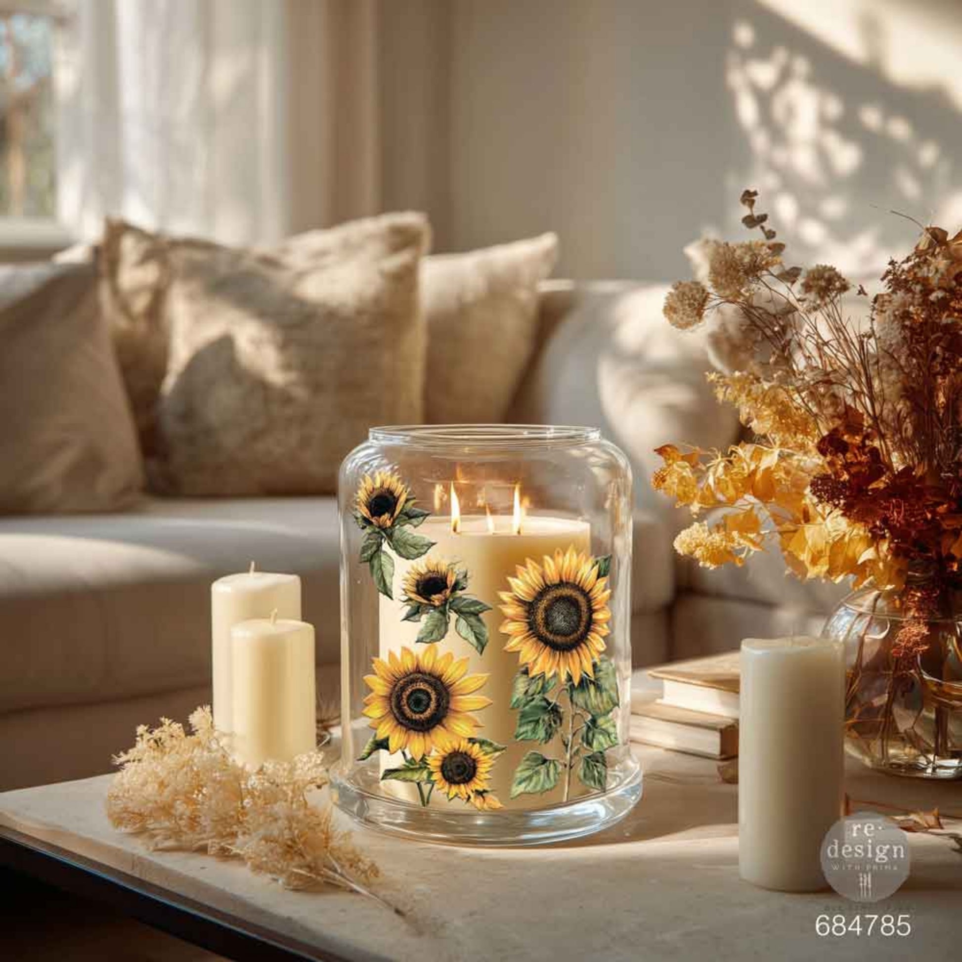 Large glass candle hurricane decorated with yellow sunflower Luxe Transfers in a warm, neutral living room setting.