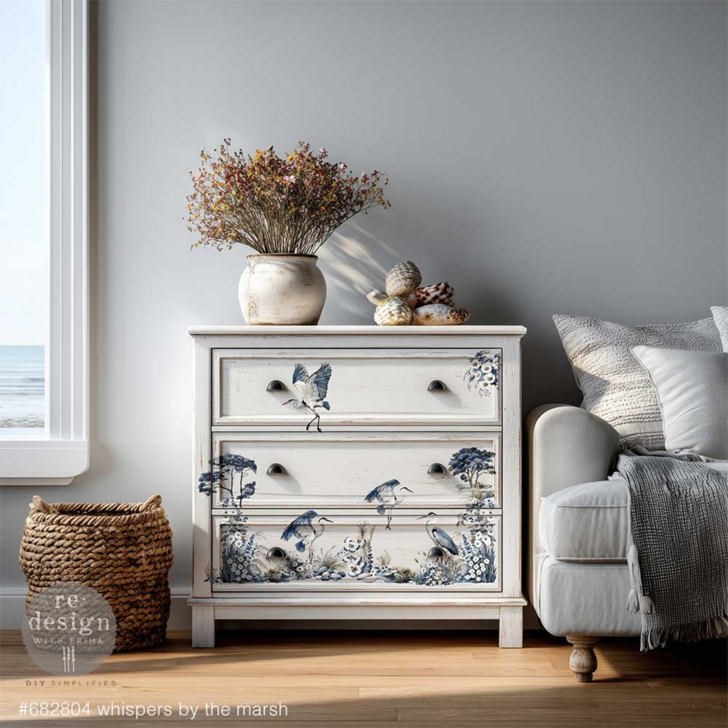 Whispers by the Marsh rub on transfer with coastal marsh birds, grasses, stones, and floral elements on a white dresser