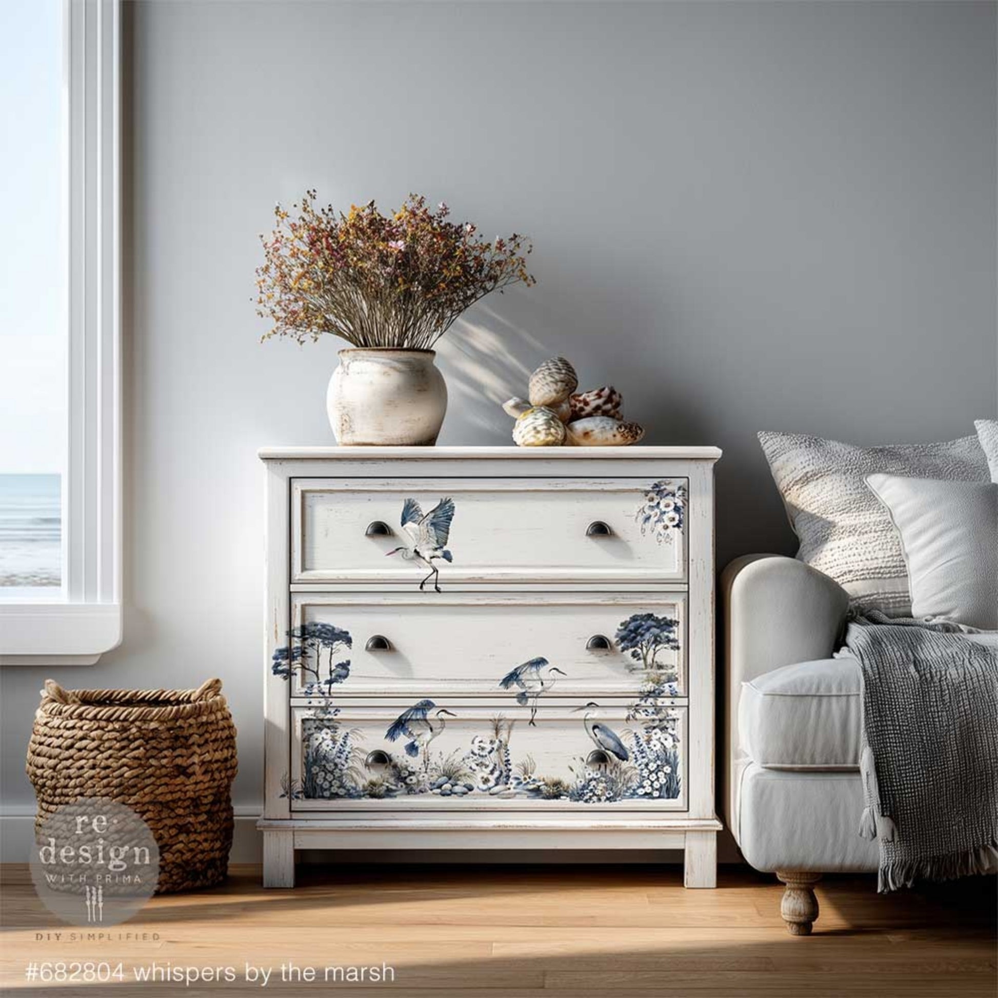 Whispers by the Marsh rub on transfer with coastal marsh birds, grasses, stones, and floral elements on a white dresser