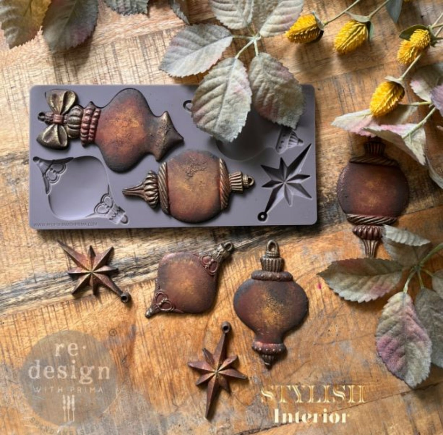 Four floral Winter Luxe Blanks ornaments hanging on a tabletop Christmas tree styled with blush roses, pearls, lace, and vintage books.
